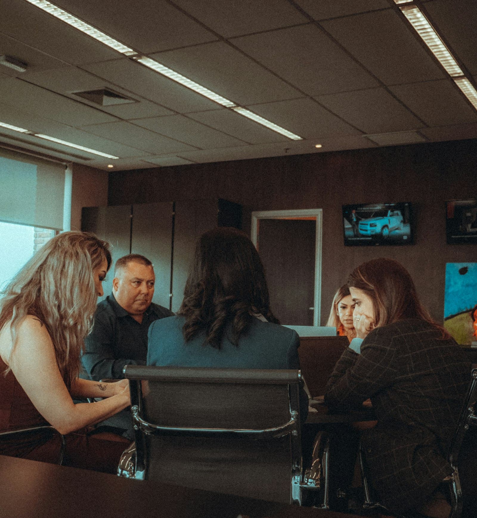 People talking around a conference table in an office